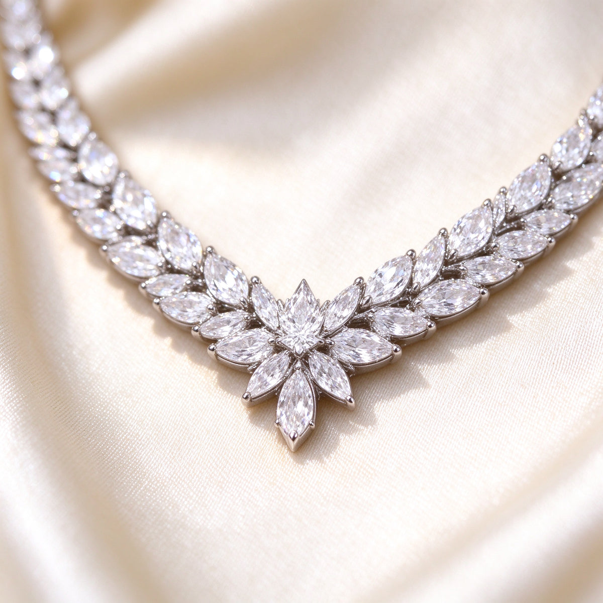 Macro detail of The Coronet Bridal Set V-collar necklace center starburst of marquise clear CZ