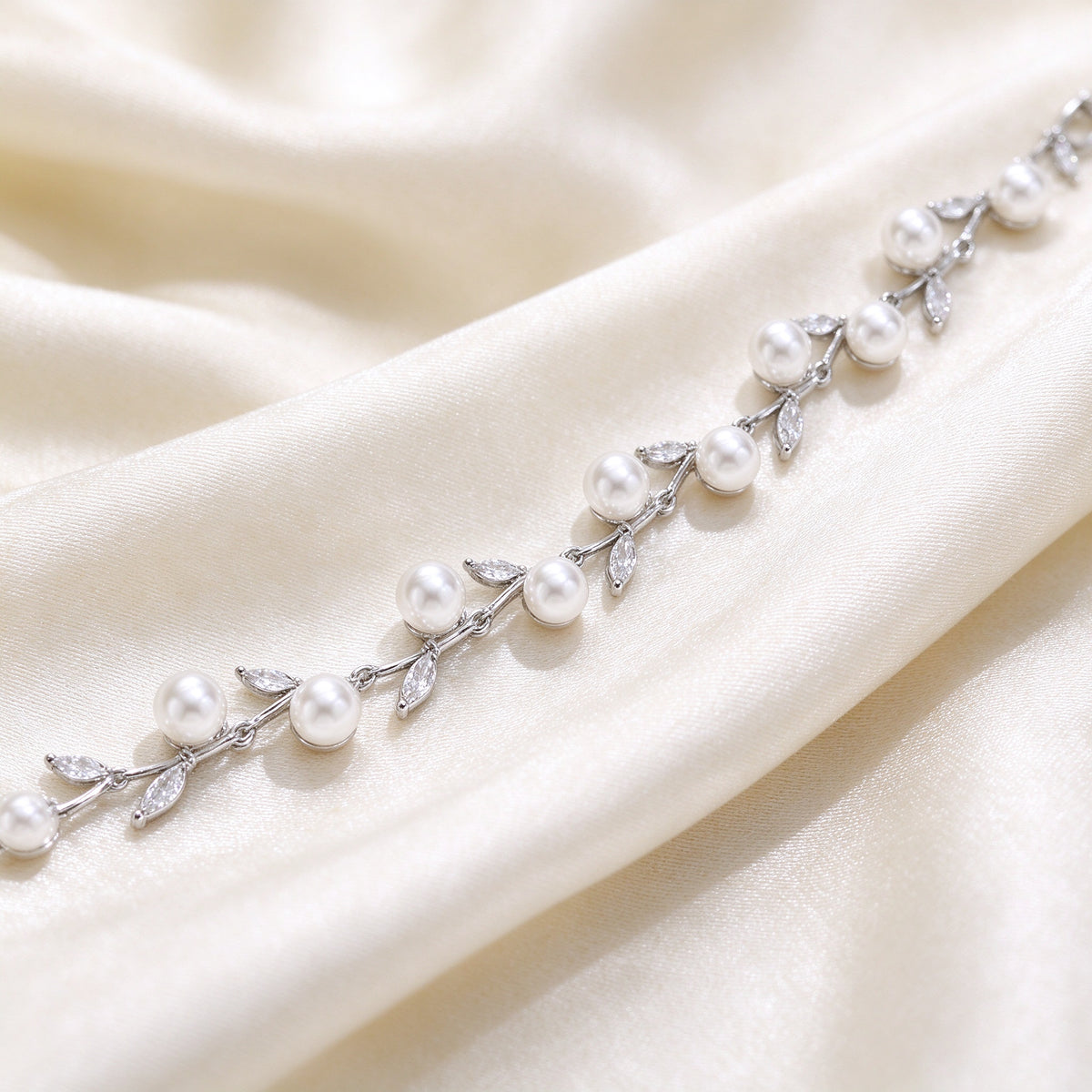 Macro detail of The Alpine Crystal Parure pearl and marquise CZ vine chain