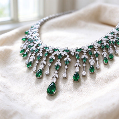 Macro detail of The Sheaf Wedding Suite fringe bib necklace with cascading emerald-green pear and marquise CZ drops