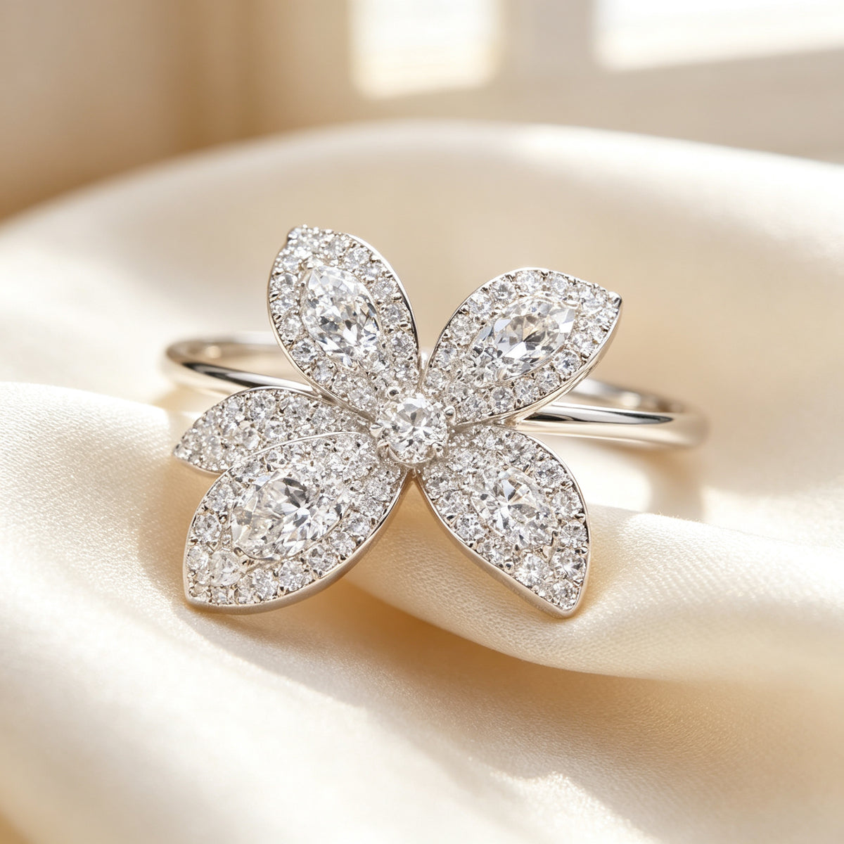 Macro detail of micro-pavé cubic zirconia four-petal orchid flower on cream silk