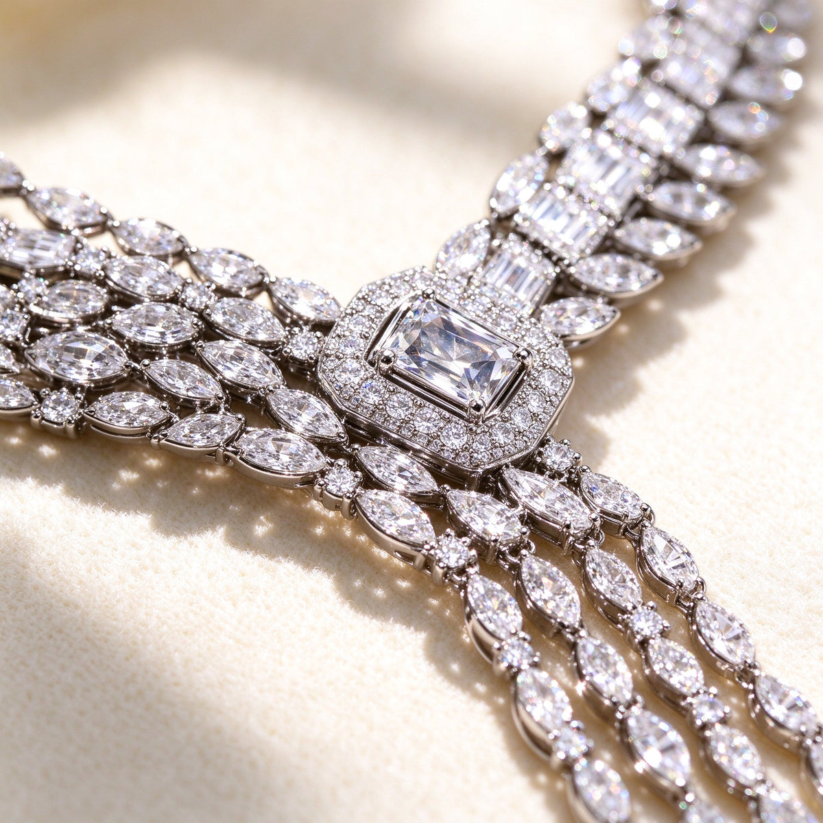 Macro detail of The Harvest Bridal Parure marquise CZ links meeting at the central emerald-cut stone