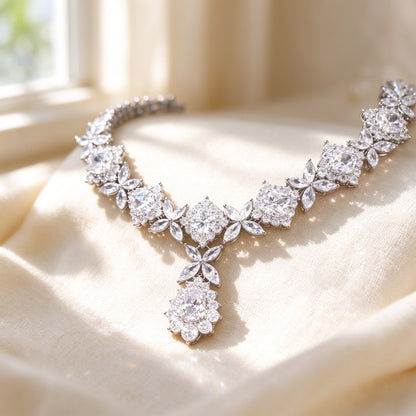 Macro close-up of The Rowan marquise and round clear cubic zirconia leaves with pear cluster on ivory silk