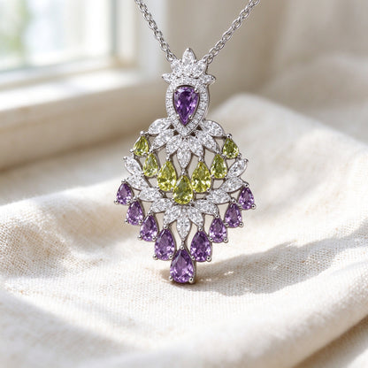 Macro detail of The Wheat Crystal Parure chandelier pendant with purple and green pear-cut CZ drops