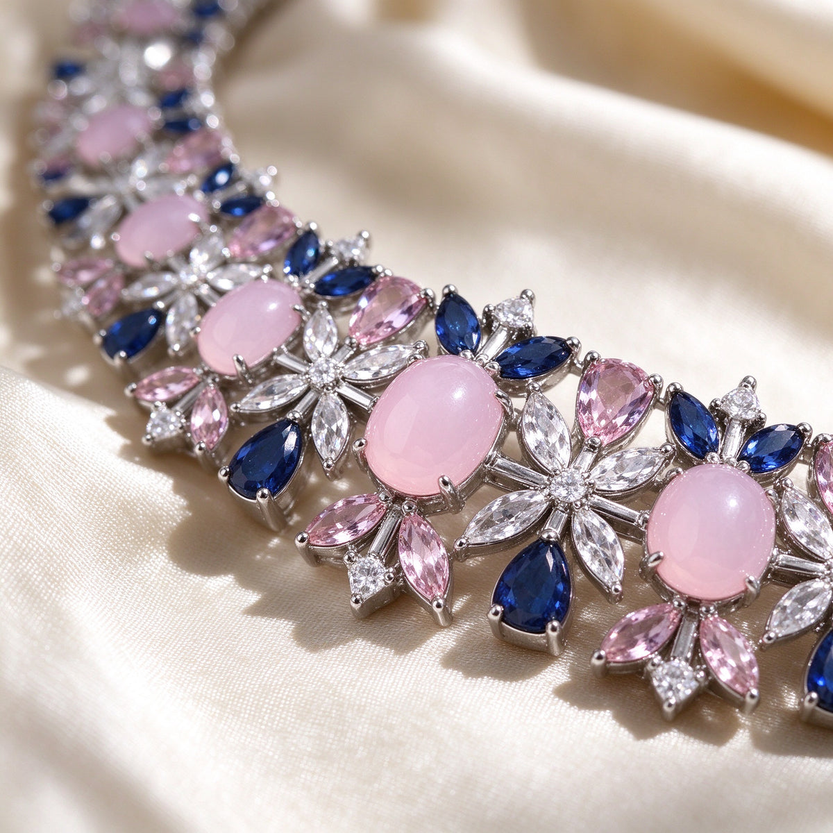 Macro of The Calliope Bridal Set floral station with oval pink cabochon and radiating clear marquise CZ petals