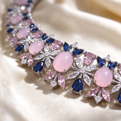Macro of The Calliope Bridal Set floral station with oval pink cabochon and radiating clear marquise CZ petals