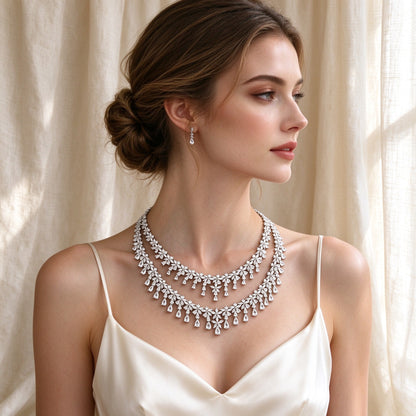Western bride wearing The Crest cascading marquise and pear CZ V-necklace in ivory silk