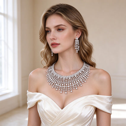 Model wearing The Comet Crystal Parure fringed bib necklace and chandelier earrings in ivory off-shoulder gown