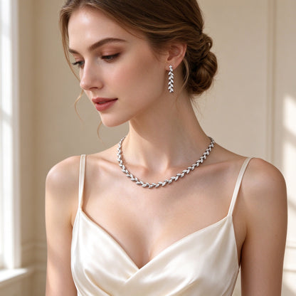 Bride wearing The Summit Wedding Suite leaf collar necklace and short drop earrings