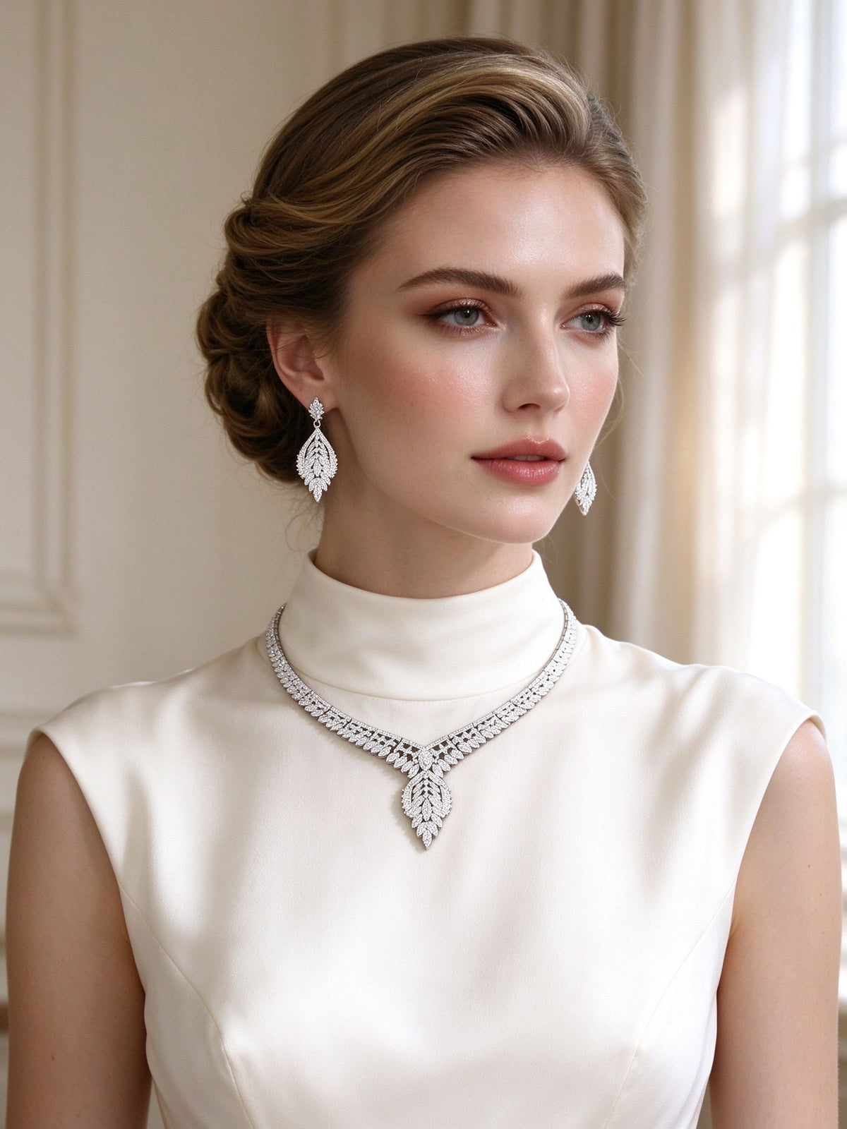 Bride wearing The Petal Bridal Set art-deco leaf pendant necklace and teardrop earrings