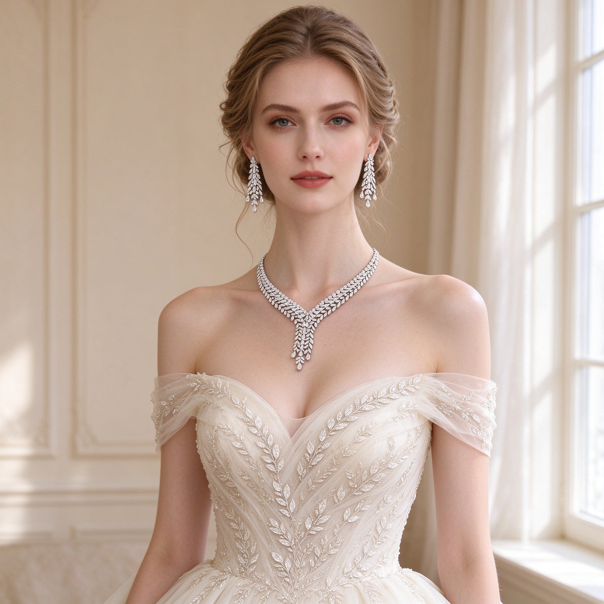 Bride in an ivory off-shoulder gown wearing The Peyton cascading leaf CZ necklace and drop earrings