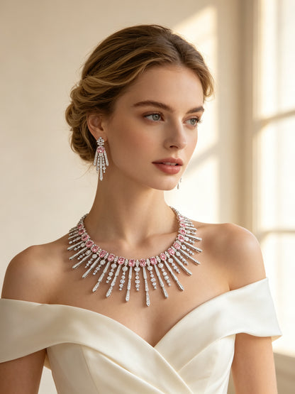 Bride in an ivory off-shoulder gown wearing The Amara Wedding Parure sunburst fringe necklace and drop earrings