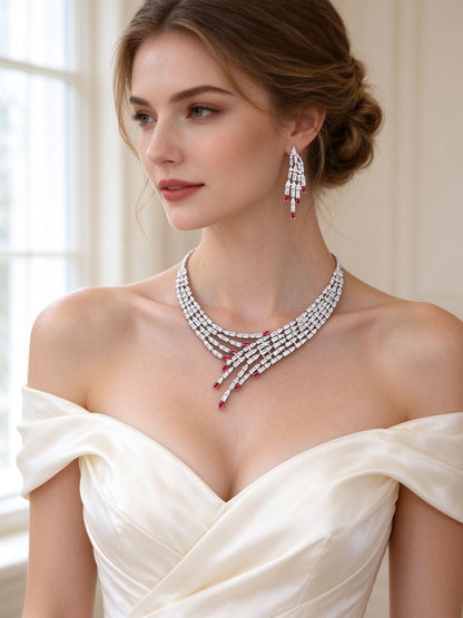 Bride in an ivory off-shoulder gown wearing The Maeve Bridal Parure waterfall baguette necklace and chandelier earrings