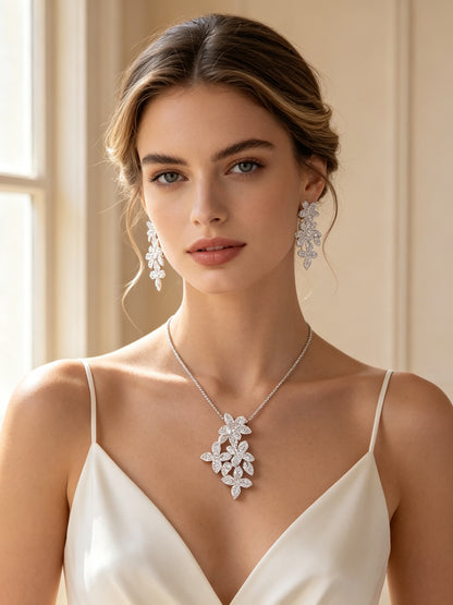 Bridal model wearing The Cosmo Bridal Parure cascading flower pendant and cluster earrings in ivory slip gown