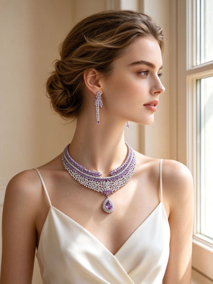 Bride wearing The Branch V-collar necklace and linear drop earrings by a window