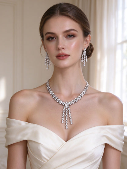 Bride wearing The Meadow Wedding Suite dramatic CZ lariat necklace and chandelier earrings