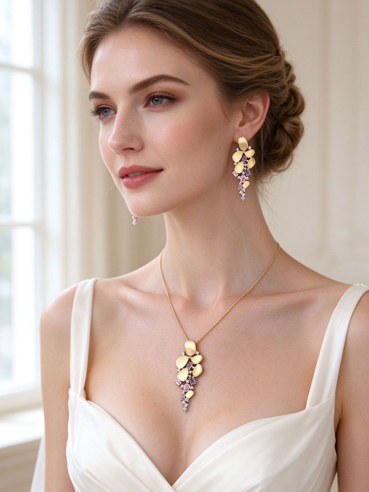 The Aurelia Bridal Set – bride wearing the gold-tone cascading pebble necklace and drop earrings