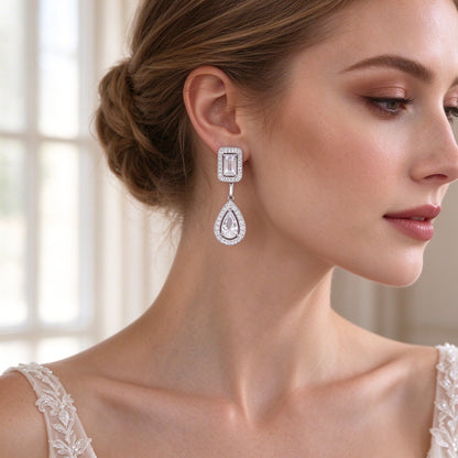 Close-up of bride's ear wearing The Celestia Wedding Suite emerald-to-pear halo drop earring
