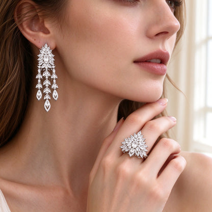 Close-up of tiered chandelier CZ drop earrings and sunburst cluster ring