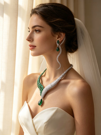 Side detail of The Ophelia Crystal Parure showing the twisted ribbon curving along the collarbone to the green pear teardrop drop