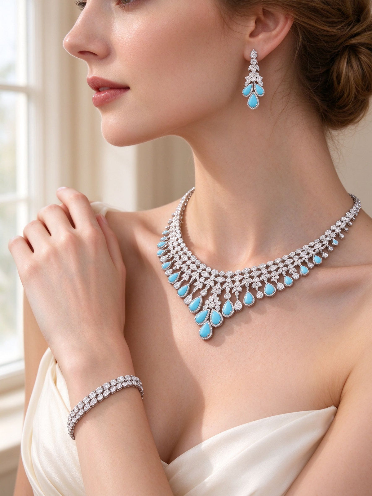 Side detail of The Marlowe Wedding Suite showing the drop earring, fringe collar and tennis bracelet at the collarbone