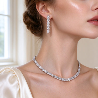 Close-up of The Thorn Wedding Suite linear marquise-drop earring and vine necklace worn at a bride's collarbone