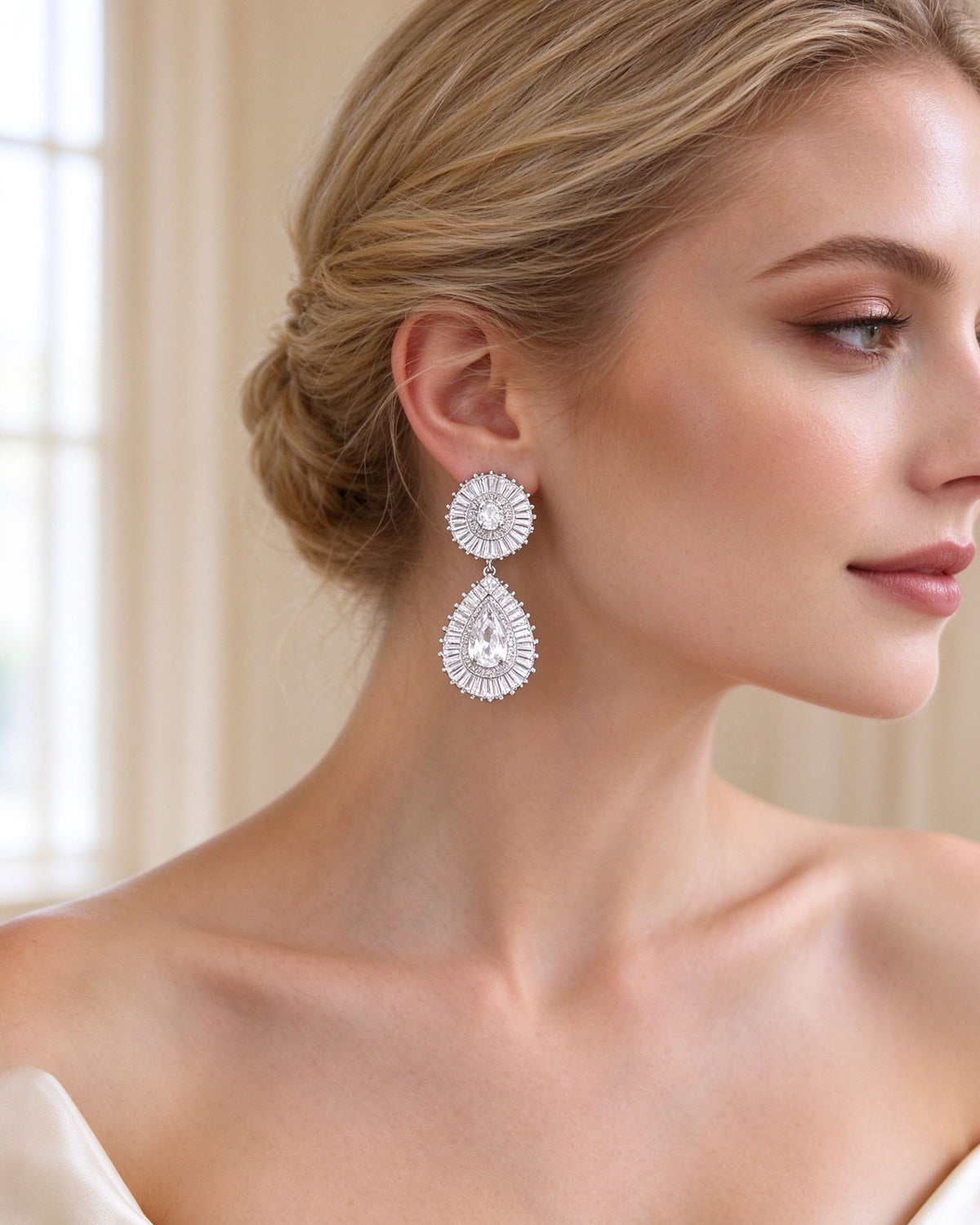 Close-up of the two-tier baguette sunburst pear-cut CZ drop earrings