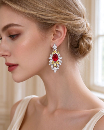 Close-up of the ruby-red floral cluster drop earrings with canary-yellow petals