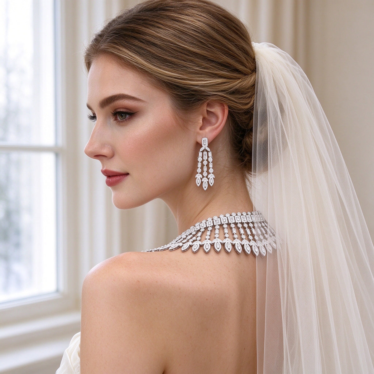 Back three-quarter view of bride in ivory tulle veil wearing The Jasmine Bridal Set necklace collar and drop earrings