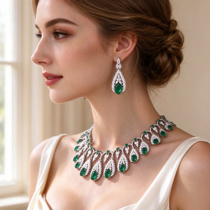 Close-up of The Zinnia Bridal Parure teardrop leaf-frame drop earrings worn by a bride