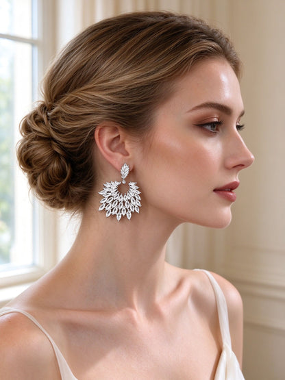 Close-up of The Skye Bridal Set leaf-wing marquise CZ drop earrings on bride