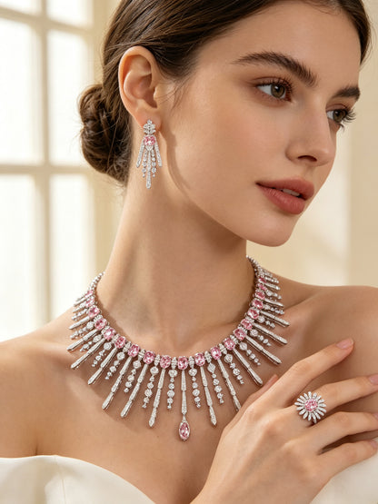 Side detail of The Amara Wedding Parure showing the fringe collar on the collarbone, a drop earring and a pink sunburst cluster ring