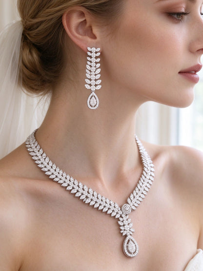 Side detail of The Cordelia Wedding Suite showing the linear leaf-drop earring and pear pendant at the collarbone