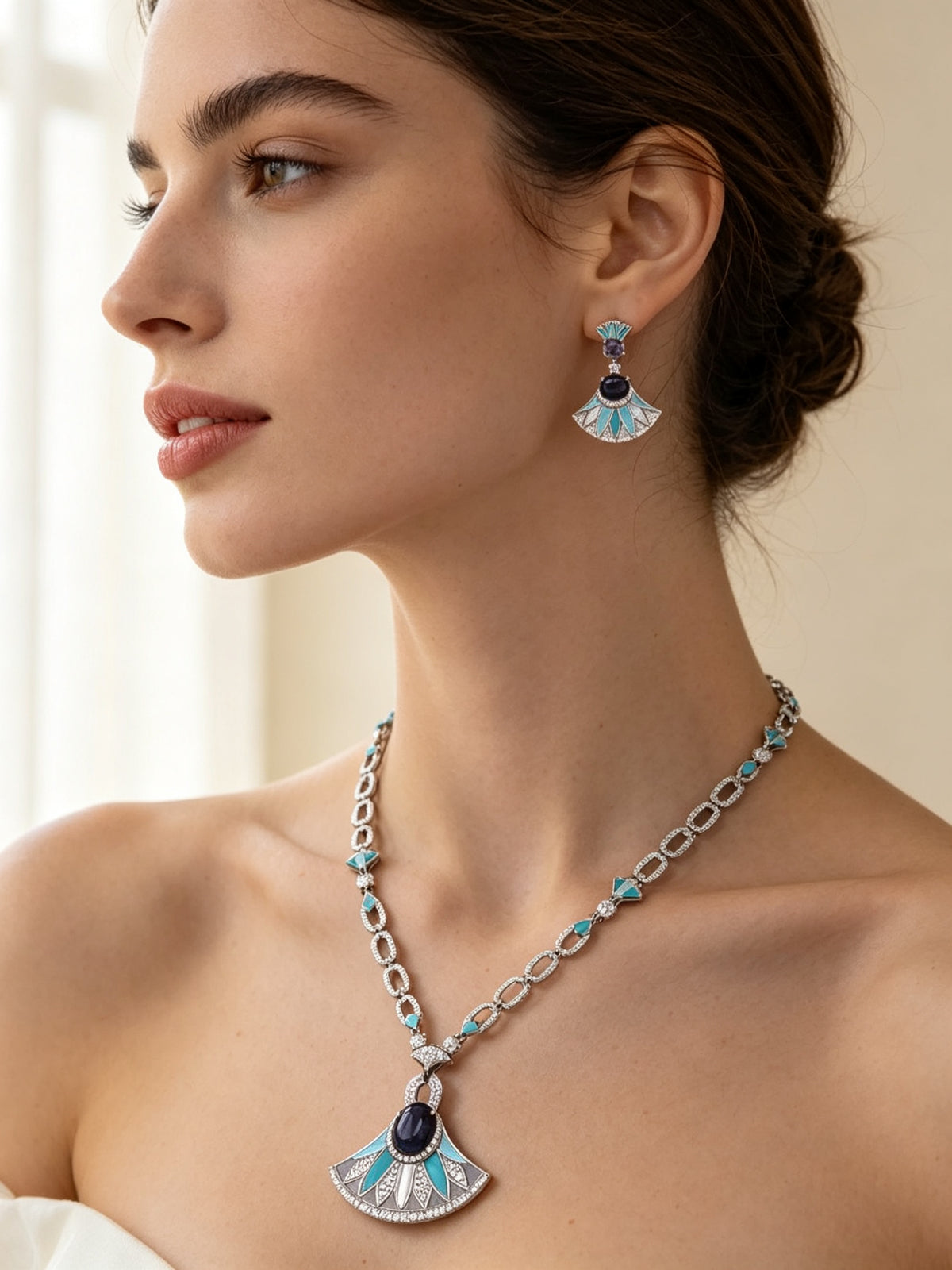 Side detail of The Evangeline Crystal Suite showing the paperclip chain on the collarbone and a turquoise enamel fan drop earring