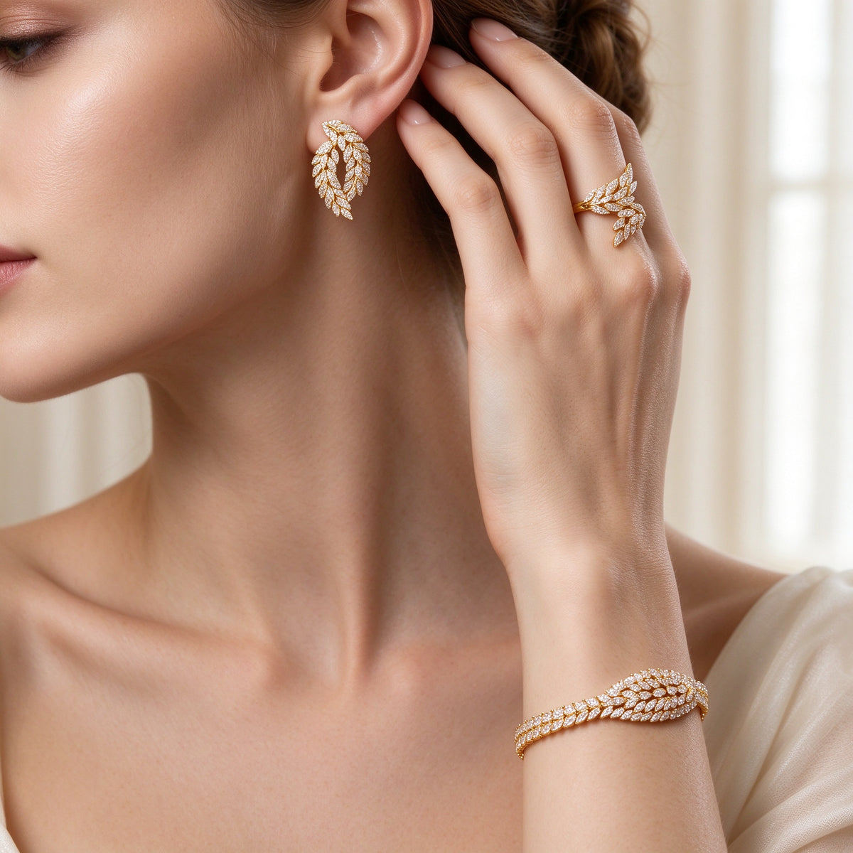 Close-up of marquise-leaf CZ earrings, ring and tennis bracelet