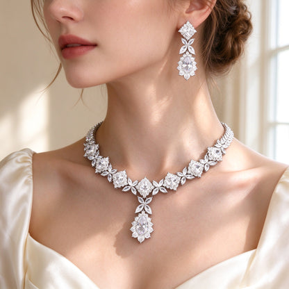 Side detail of The Rowan floral CZ collar necklace with central pear drop along the collarbone and a tiered earring