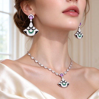 Close-up of The Camellia Bridal Parure fan-drop earrings with purple stone and green-cluster fan worn by a bride at the jawline