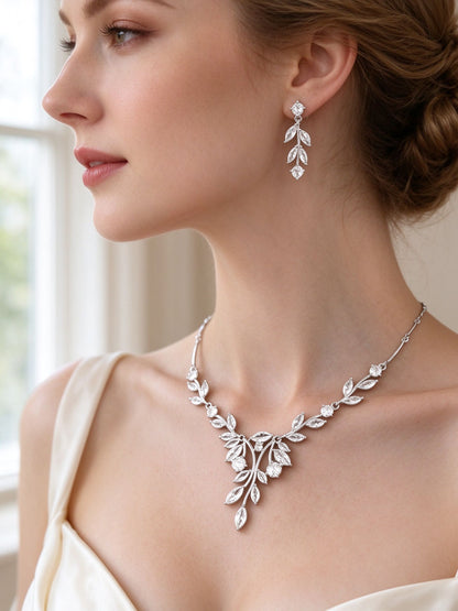 Side detail of The Delaney Wedding Suite showing the linear leaf earring and botanical V at the collarbone