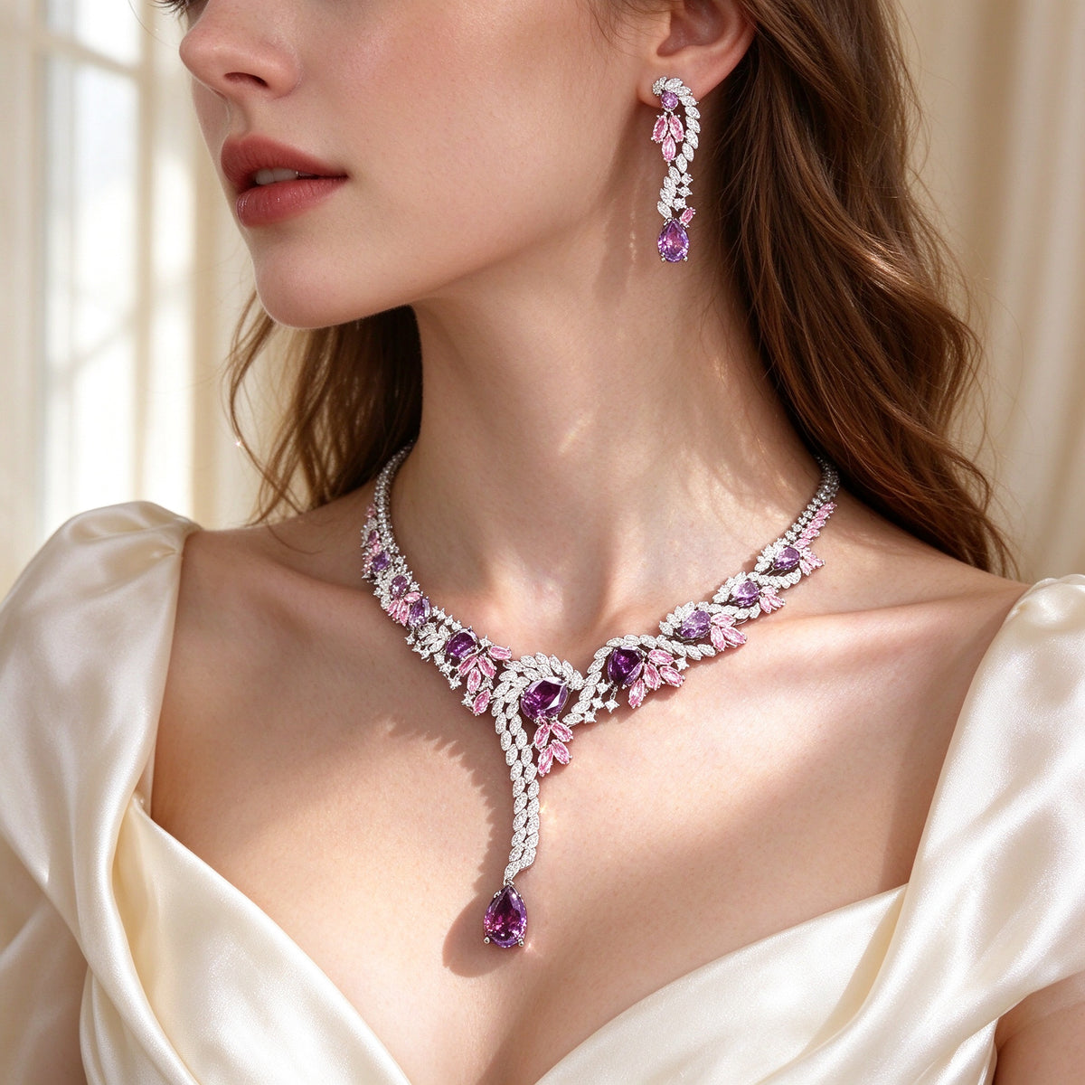 Side detail of The Nova pink-to-purple gradient CZ Y-necklace with long pear pendant along the collarbone