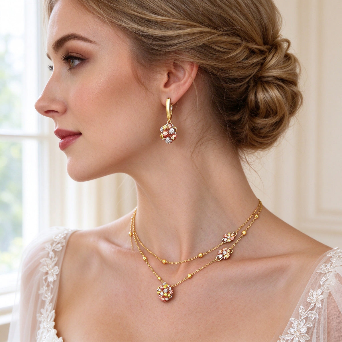 Close-up of a bride's ear and neck showing The Sunbeam Crystal Parure delicate gold tri-color flower drop earring and layered chain