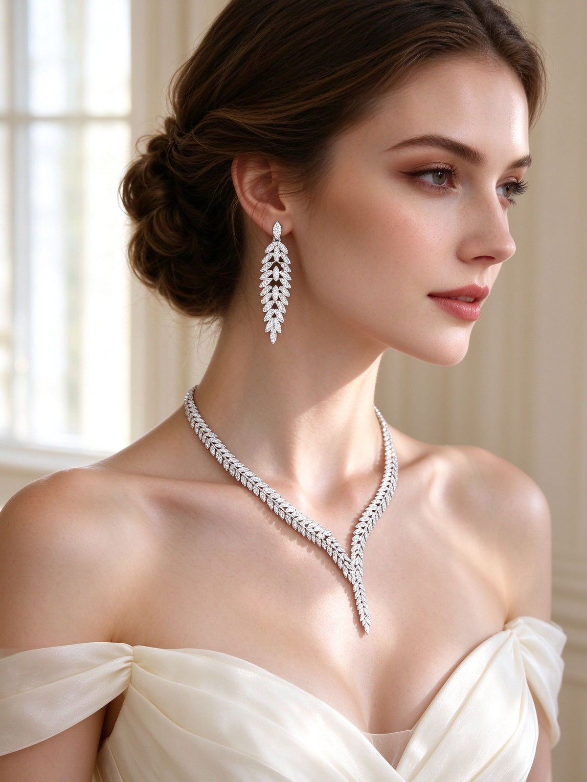 Side detail of The Elowen Wedding Suite showing the branch drop earring and V-necklace along the collarbone
