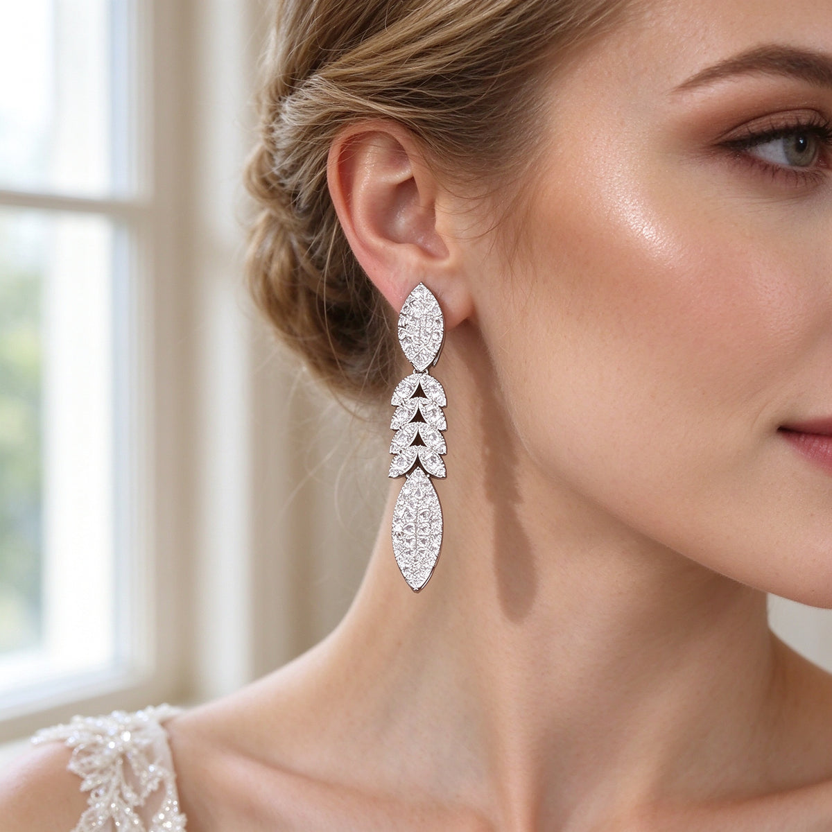 Close-up of bride's ear wearing The Luna Crystal Set linear marquise pavé drop earring