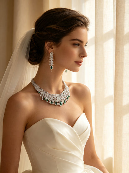 Side detail of The Estelle Crystal Suite showing the graduated teardrop collar on the collarbone and a green chandelier earring