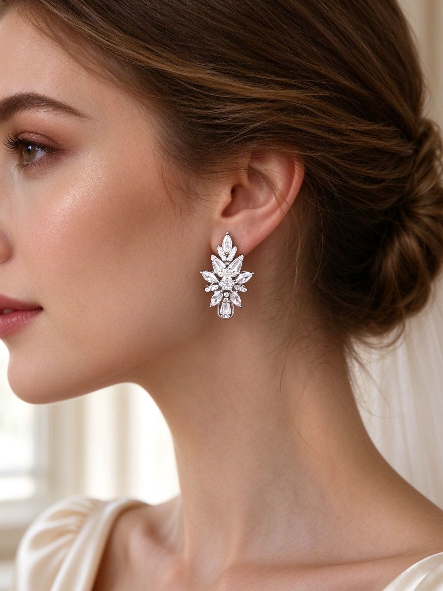 Close-up of bride's ear wearing The Coronet Bridal Set vertical marquise-leaf cluster CZ drop earring