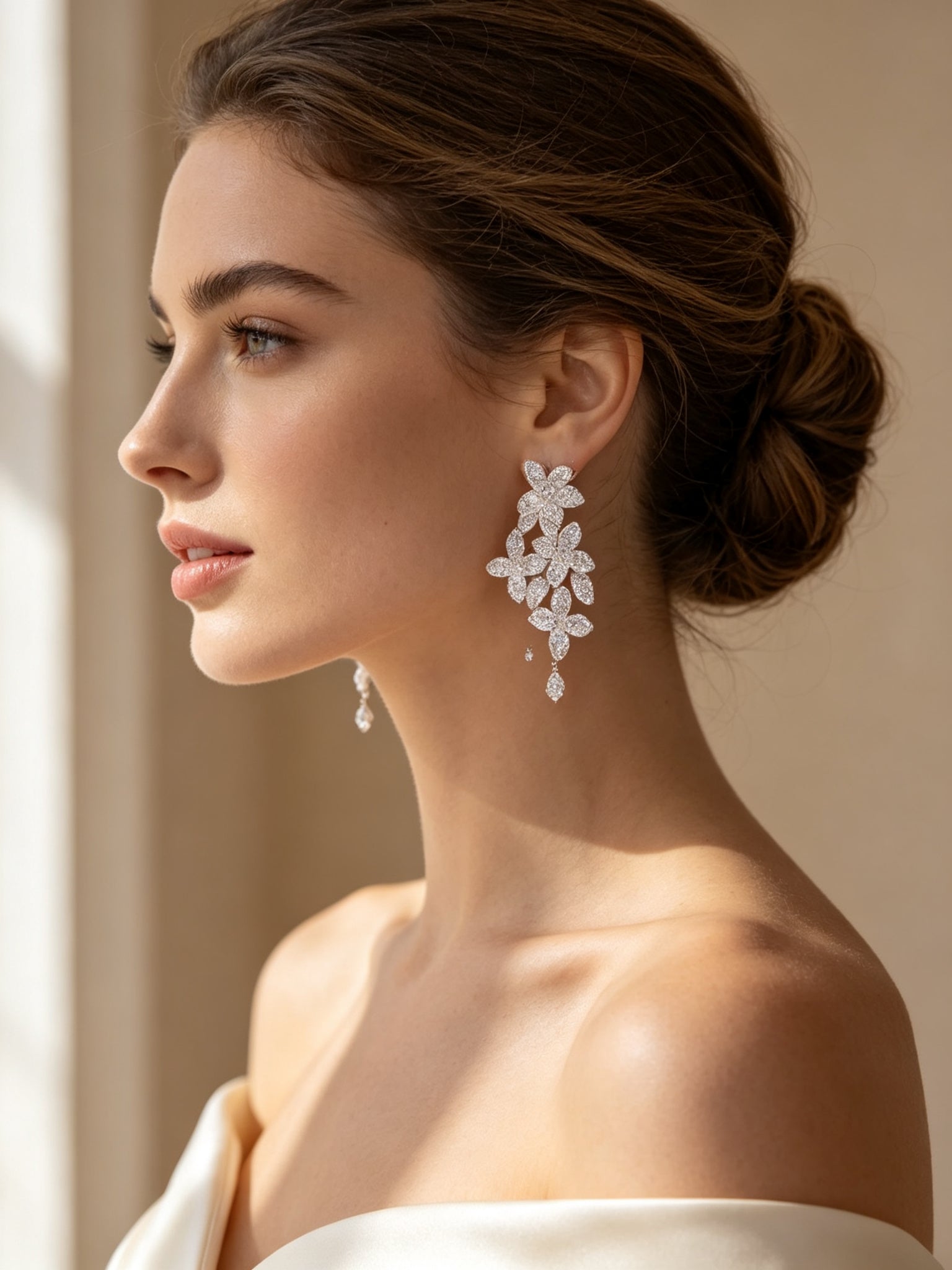 Side profile close-up of bride wearing The Cosmo pavé CZ flower cluster drop earring