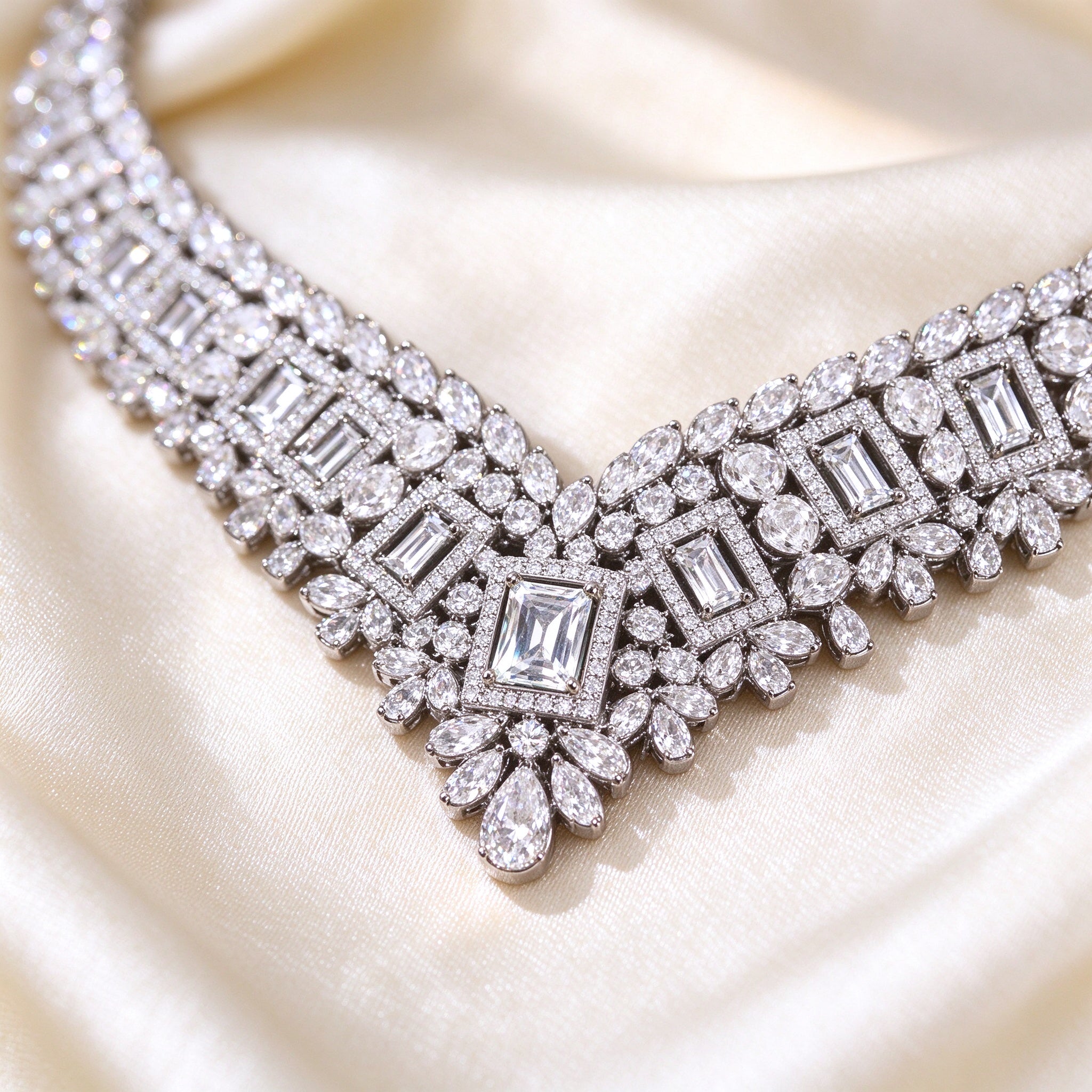 Macro detail of The Diadem Bridal Parure V-collar necklace center with rectangular step-cut clear CZ