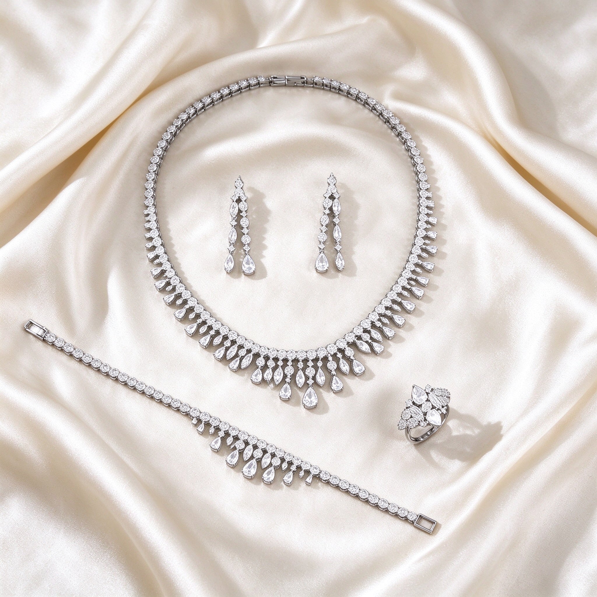 The Harper Crystal Parure – complete four-piece crystal parure laid flat on cream silk satin