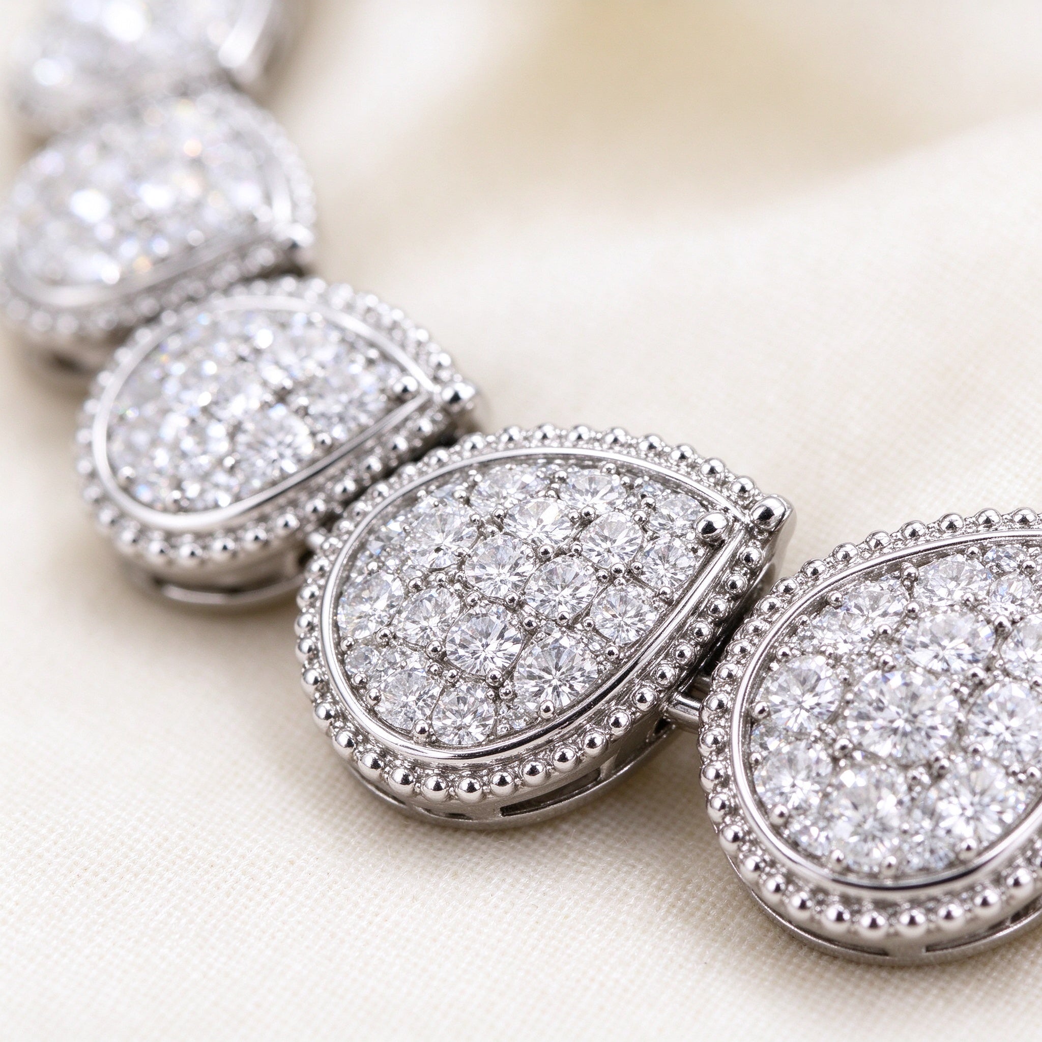 Isadora necklace detail - graduated teardrop pavé CZ with milgrain edge
