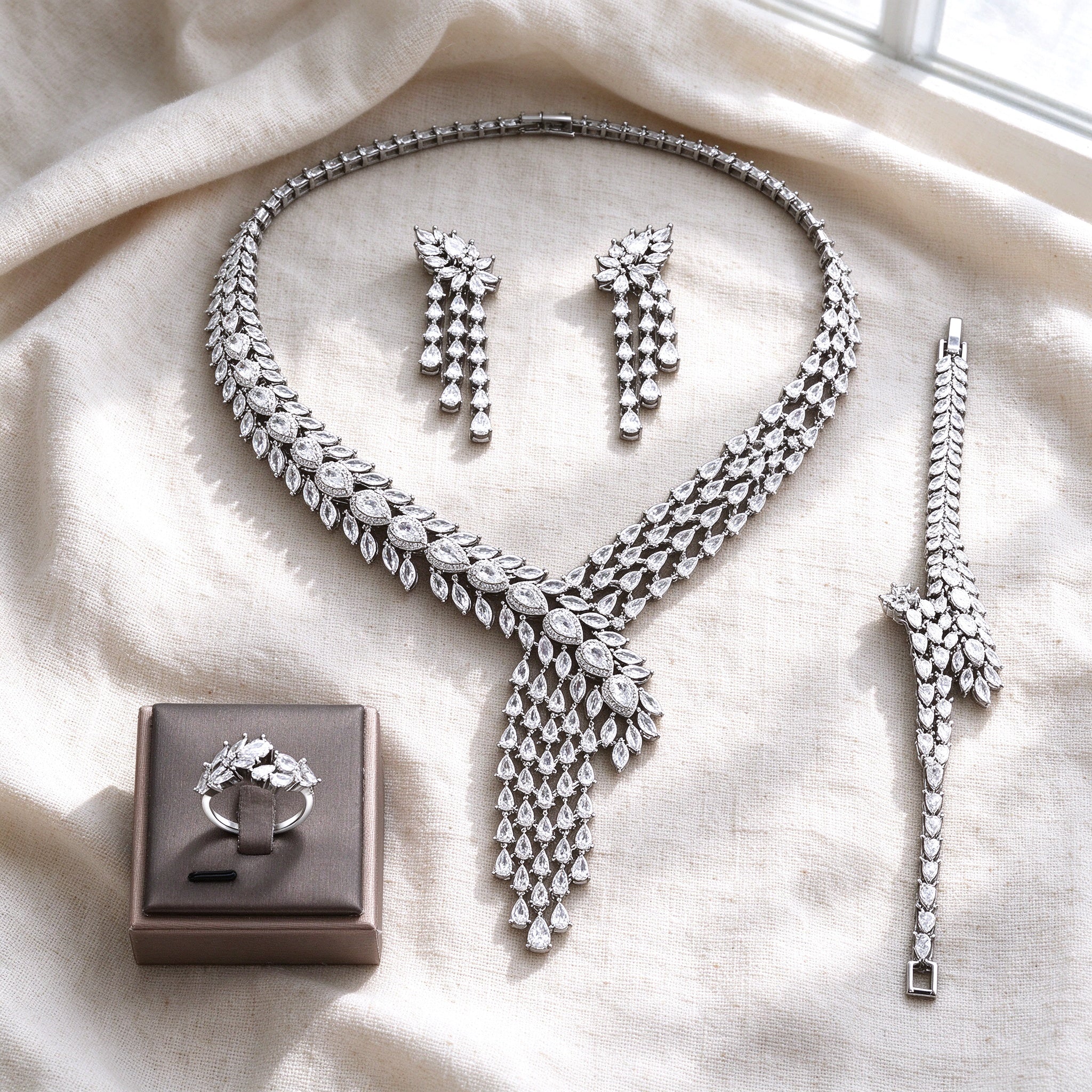 Overhead flat lay of The Marigold Wedding Suite four pieces on warm cream linen