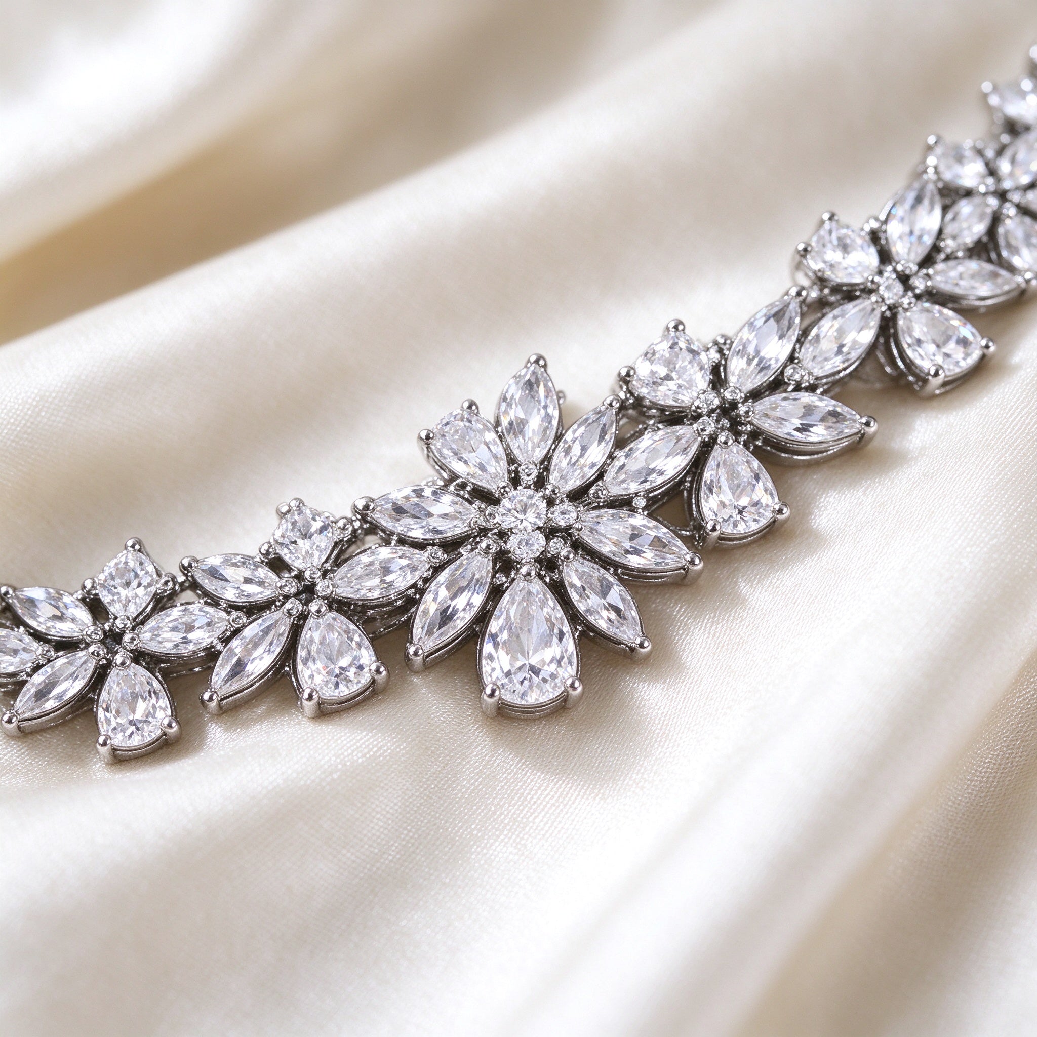 Macro detail of The Meadow Wedding Suite marquise and pear-cut CZ floral cluster