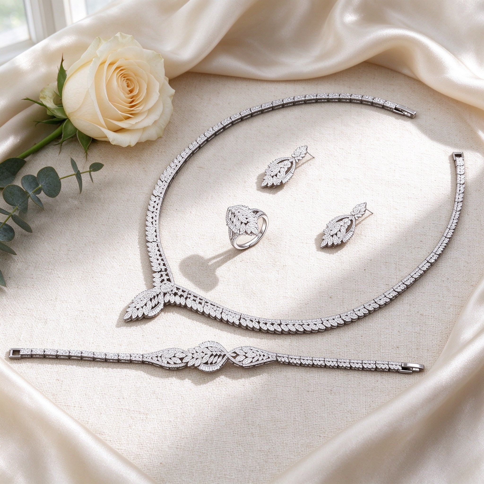 Flat lay of The Petal Bridal Set four-piece bridal set on ivory silk
